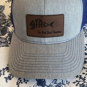 Trucker style hat with The Reel Deal Charters insignia